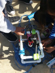 Students attach floats to add buoyancy to their ROVs.
